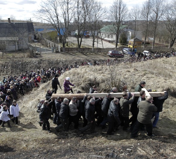 Belarussian Catholics carry a wooden cross as they take part in a procession celebrating Palm Sunday in the town of Oshmiany