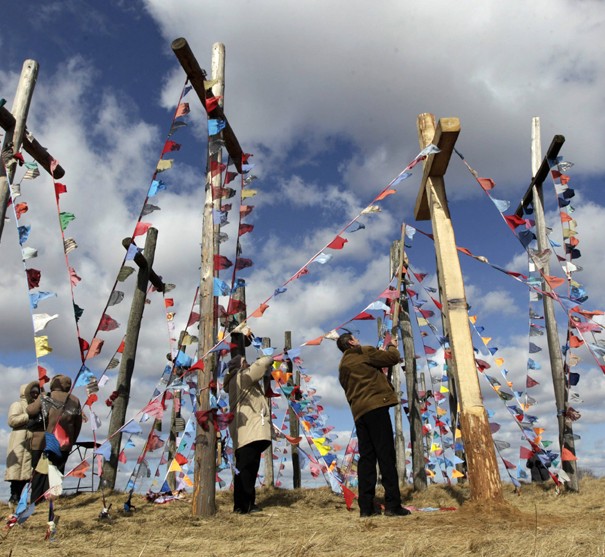 Belarussian Catholics decorate wooden crosses after the procession celebrating Palm Sunday in the town of Oshmiany
